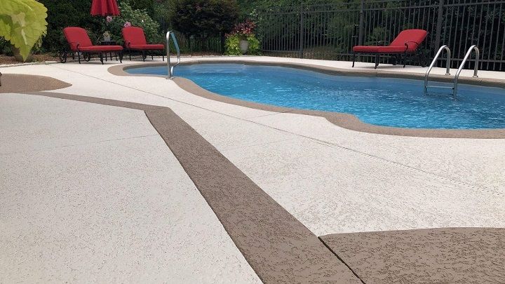 swimming pool with three red pool chairs