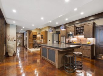 erracotta-themed kitchen with a stylish countertop table and wooden cabinets