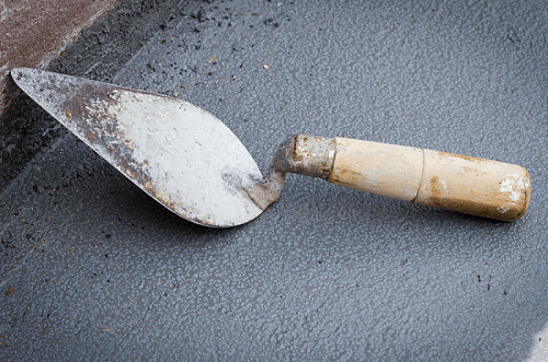 Triangle trowel laying on the ground