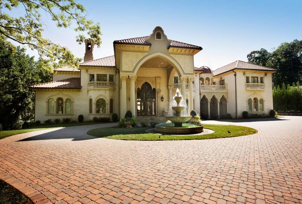 Brick driveway in front of a mansion