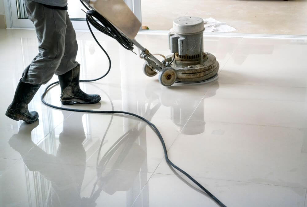 man cleaning the floor with a vacuum