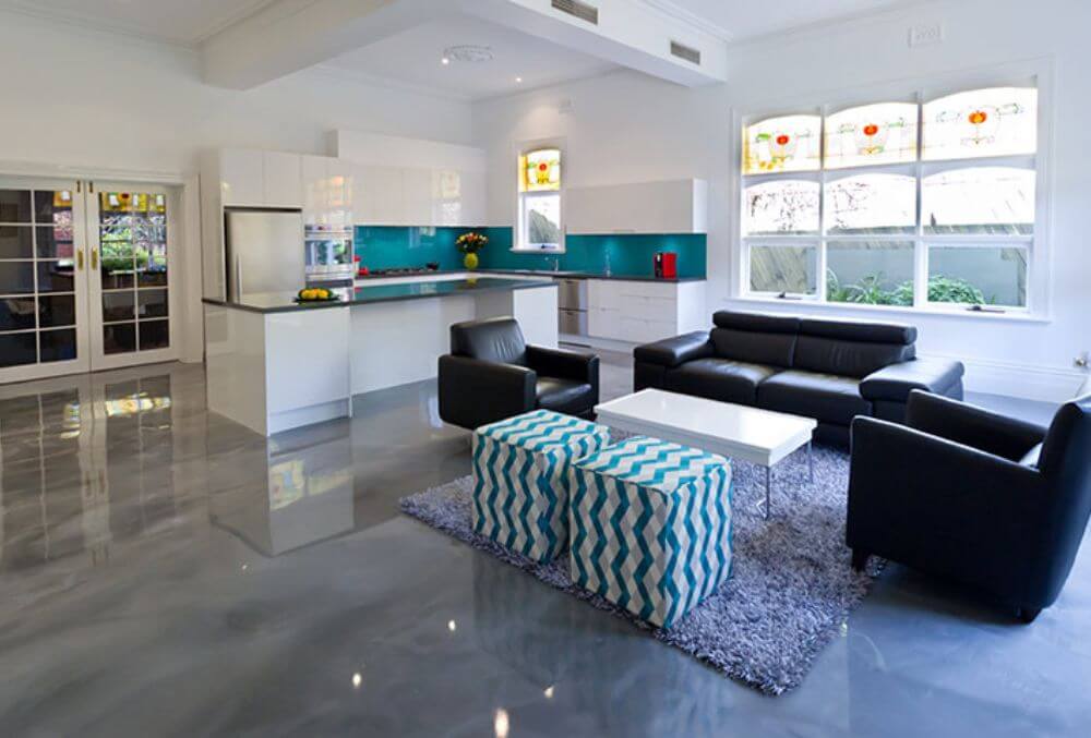 elegant living room near the kitchen with cozy couch and chairs