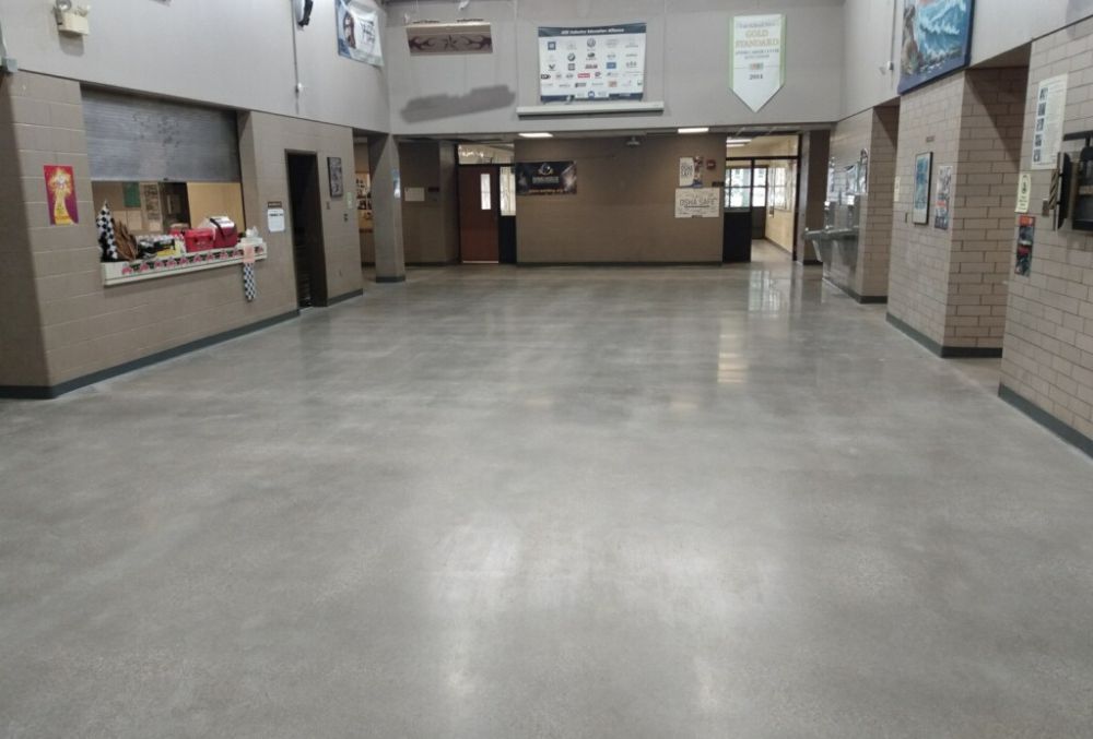 Polished concrete flooring in a school, showcasing a smooth, seamless surface designed for durability, easy maintenance, and a clean, modern learning environment.