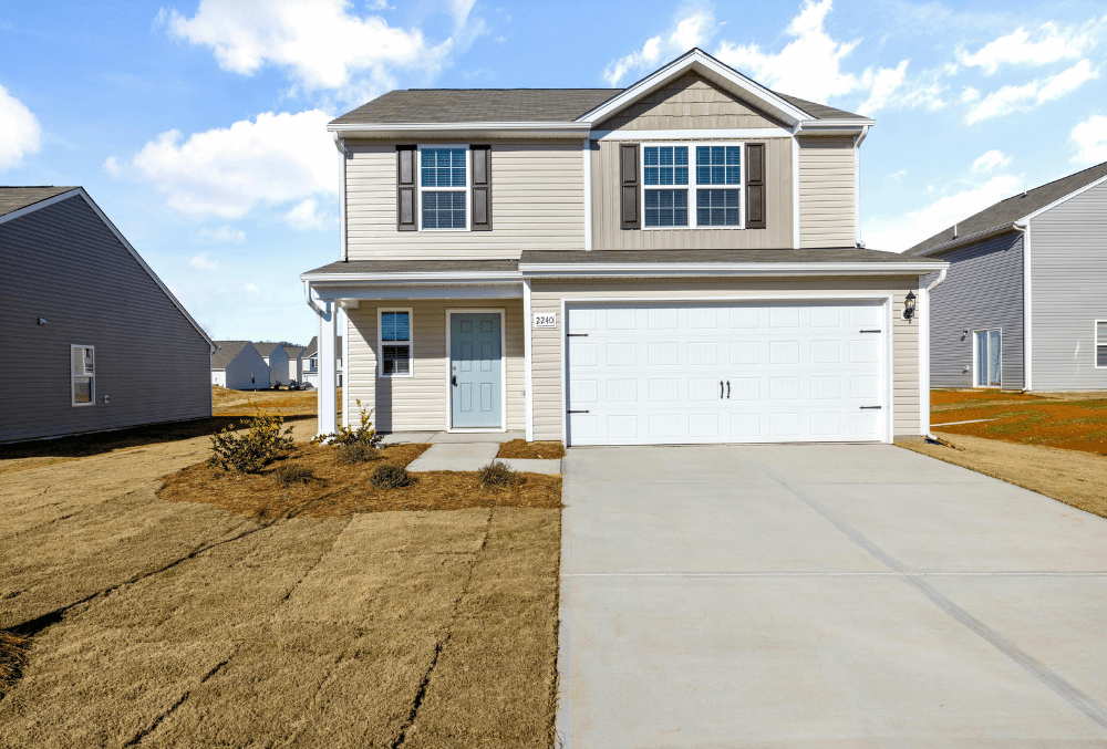 A residence with a concrete driveway and garage
