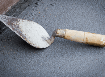 Triangle trowel laying on the ground