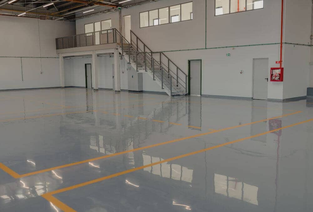 Gray epoxy floor in a clean commercial car service