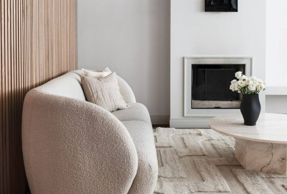 textured carpet with cozy white chair on the fireplace