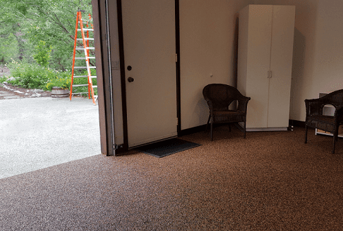 Chairs and cabinet inside a garage with polyurea floor coating