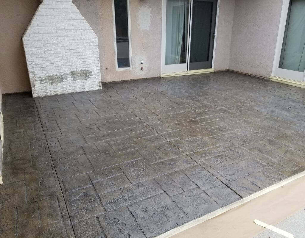 Gray stamped concrete in a back patio of a residential property