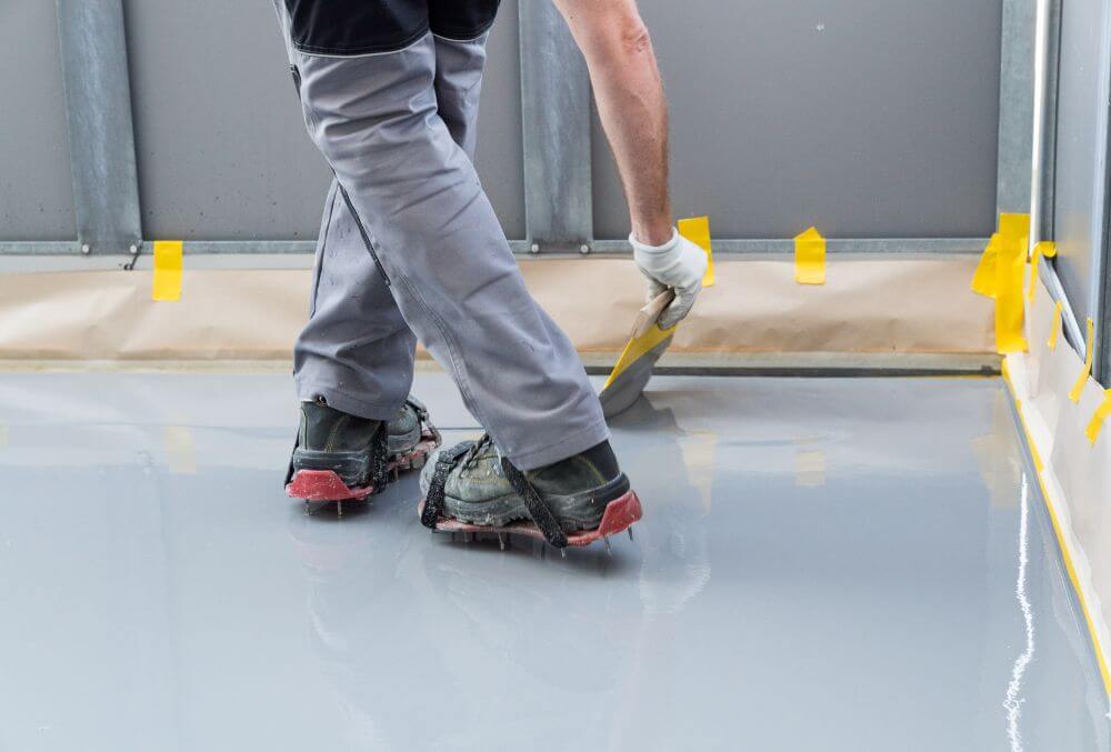 man refinishing the floor