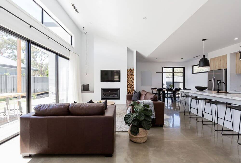 wide window in a elegant house with couch and a dining area