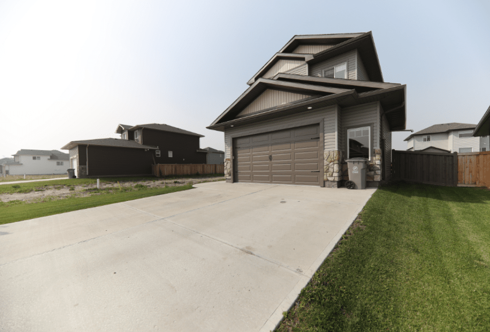 home with a garage and concrete driveway