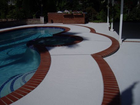 Heat-reflective concrete pool deck surface